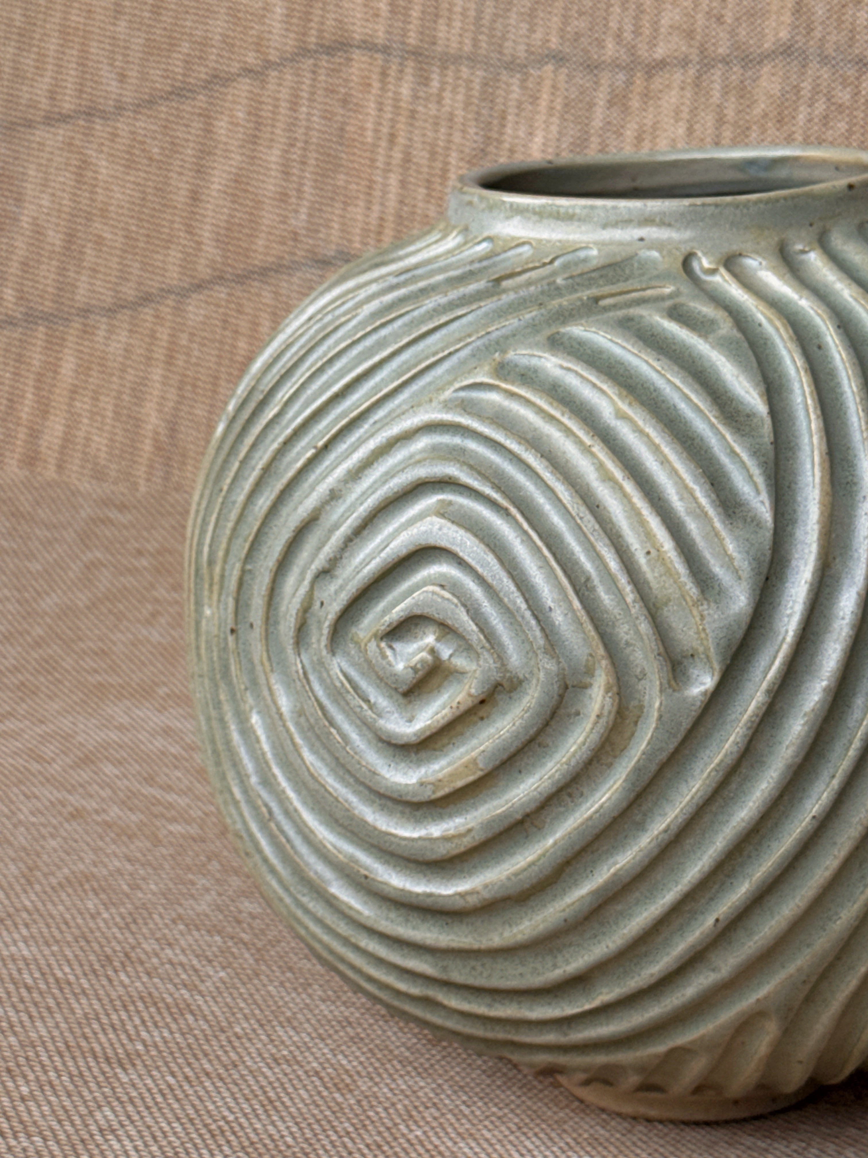 Wheel-thrown stoneware vase with hand-carved spiral grooves and pale sage glaze, Ripples collection, Singapore