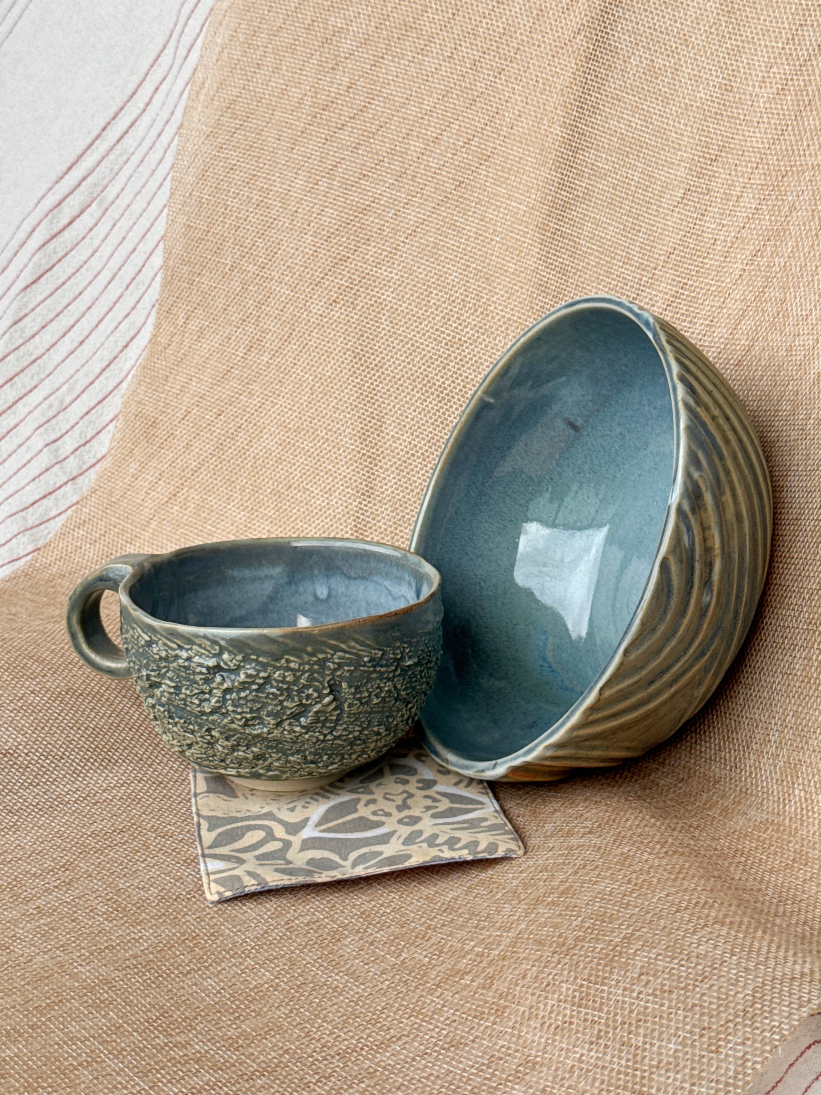 Side view of a textured stoneware cup, Ripples collection
