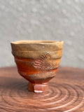 Woodfired yunomi cup with terracotta-red surface and shell-print texture, Bali