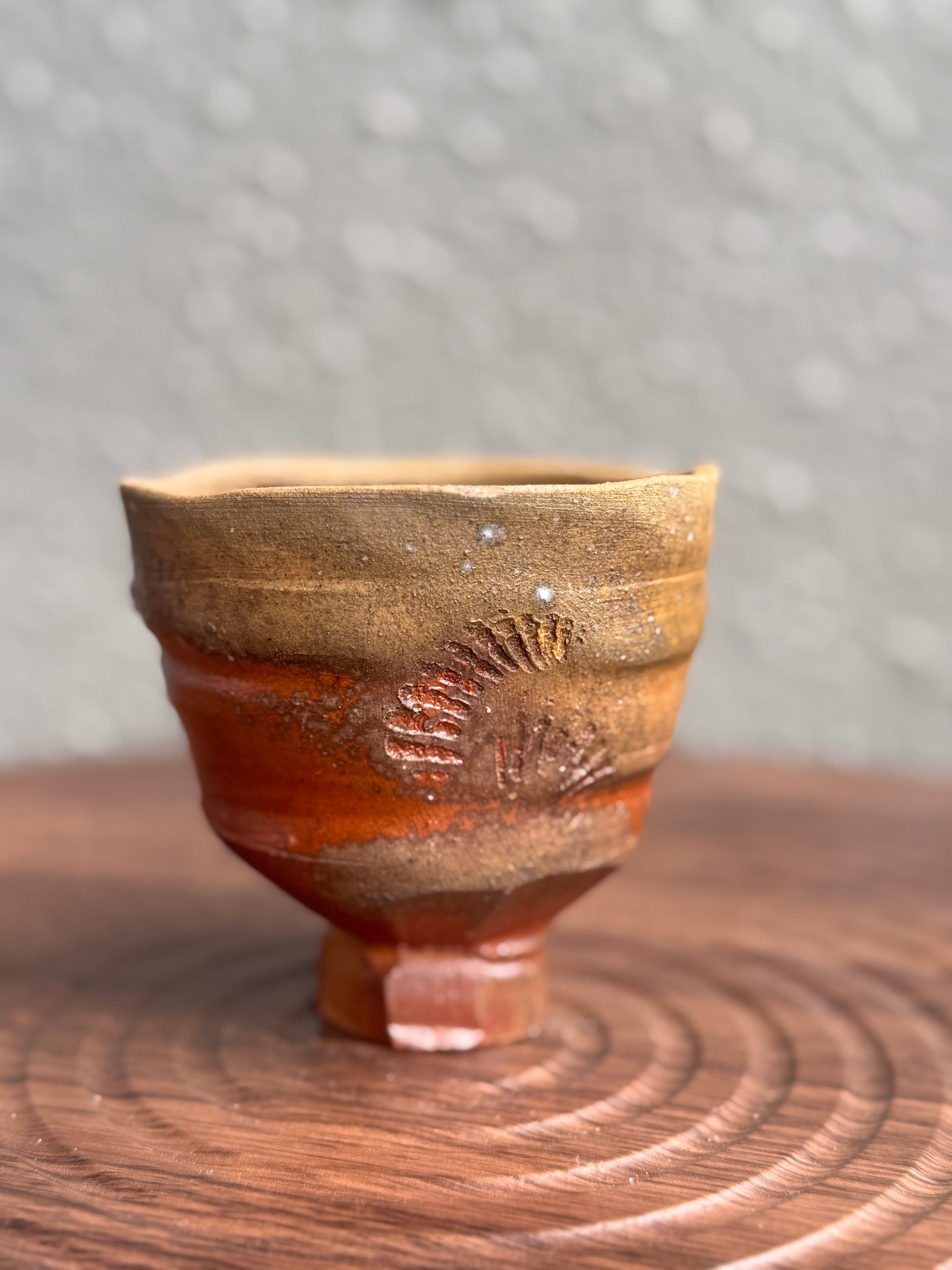 Woodfired yunomi cup with terracotta-red surface and shell-print texture, Bali