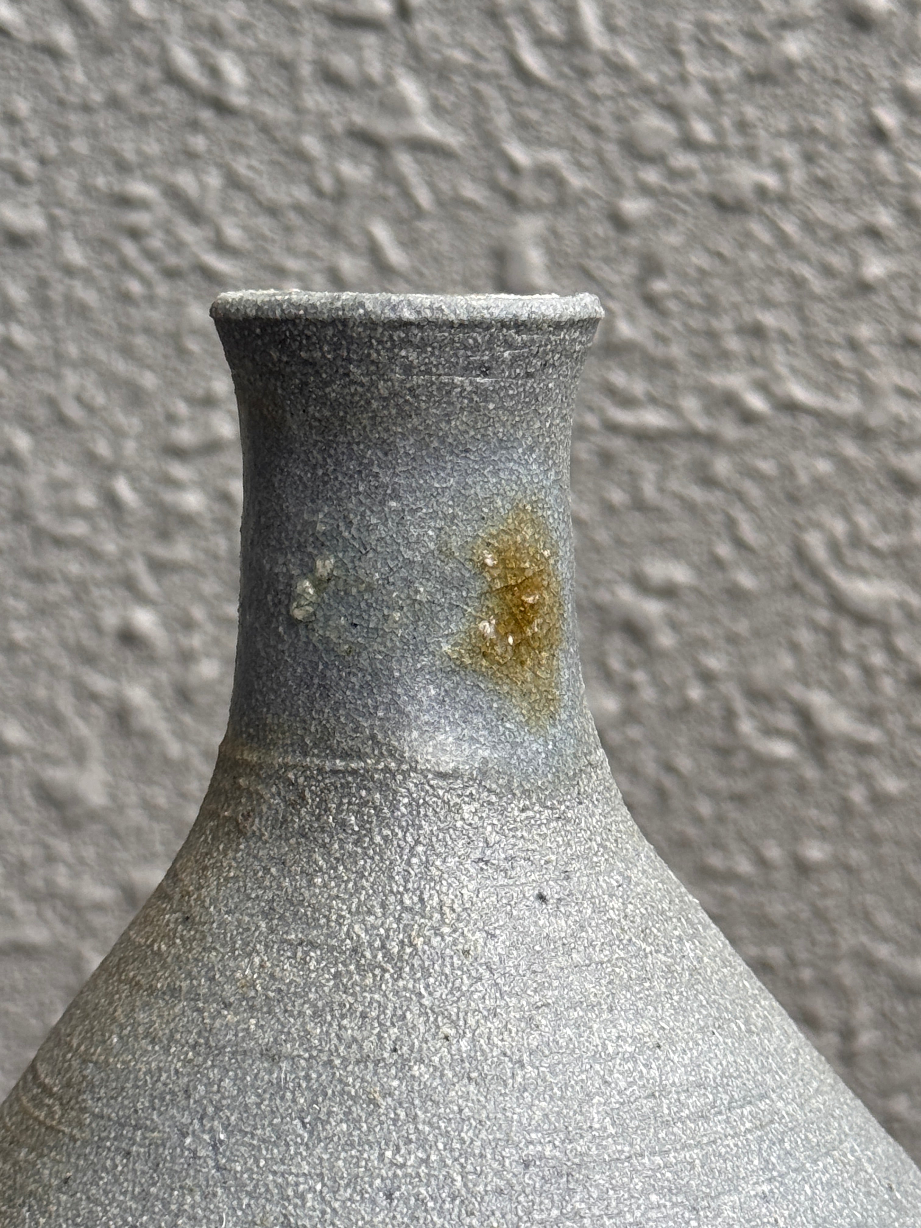 Underside of a woodfired bud vase showing natural clay color, Ubud Forest