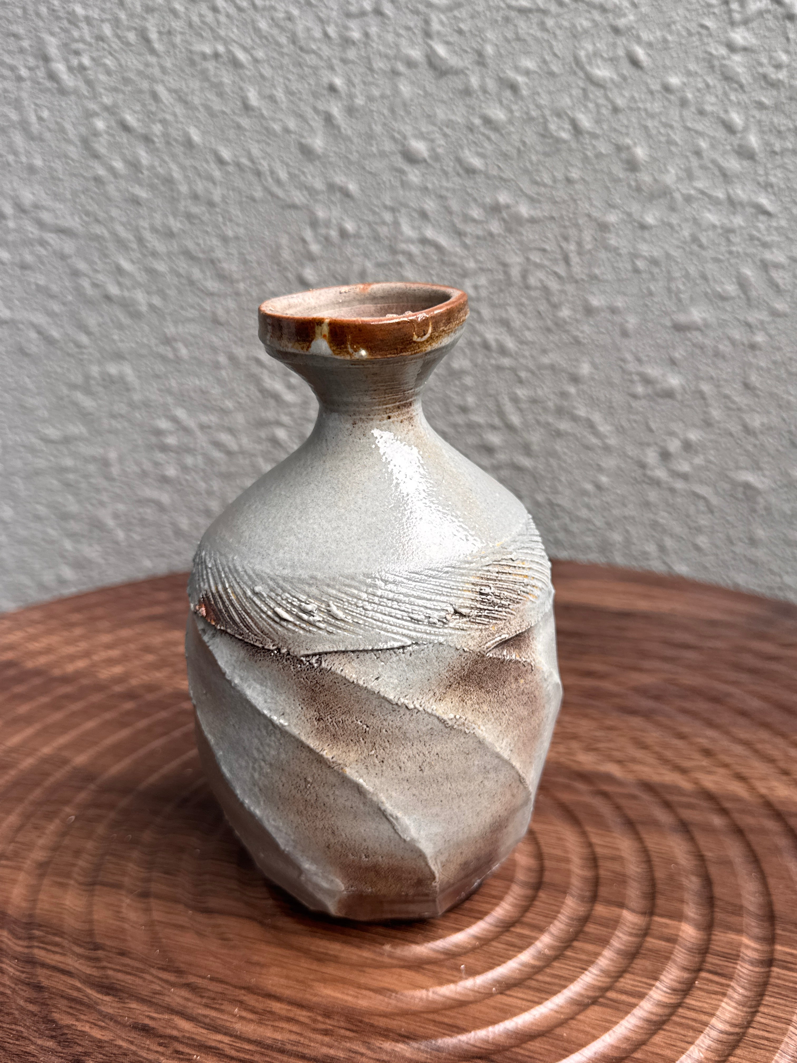 Tall faceted stoneware bottle with a structural twist, woodfired in Bali, Ubud Forest